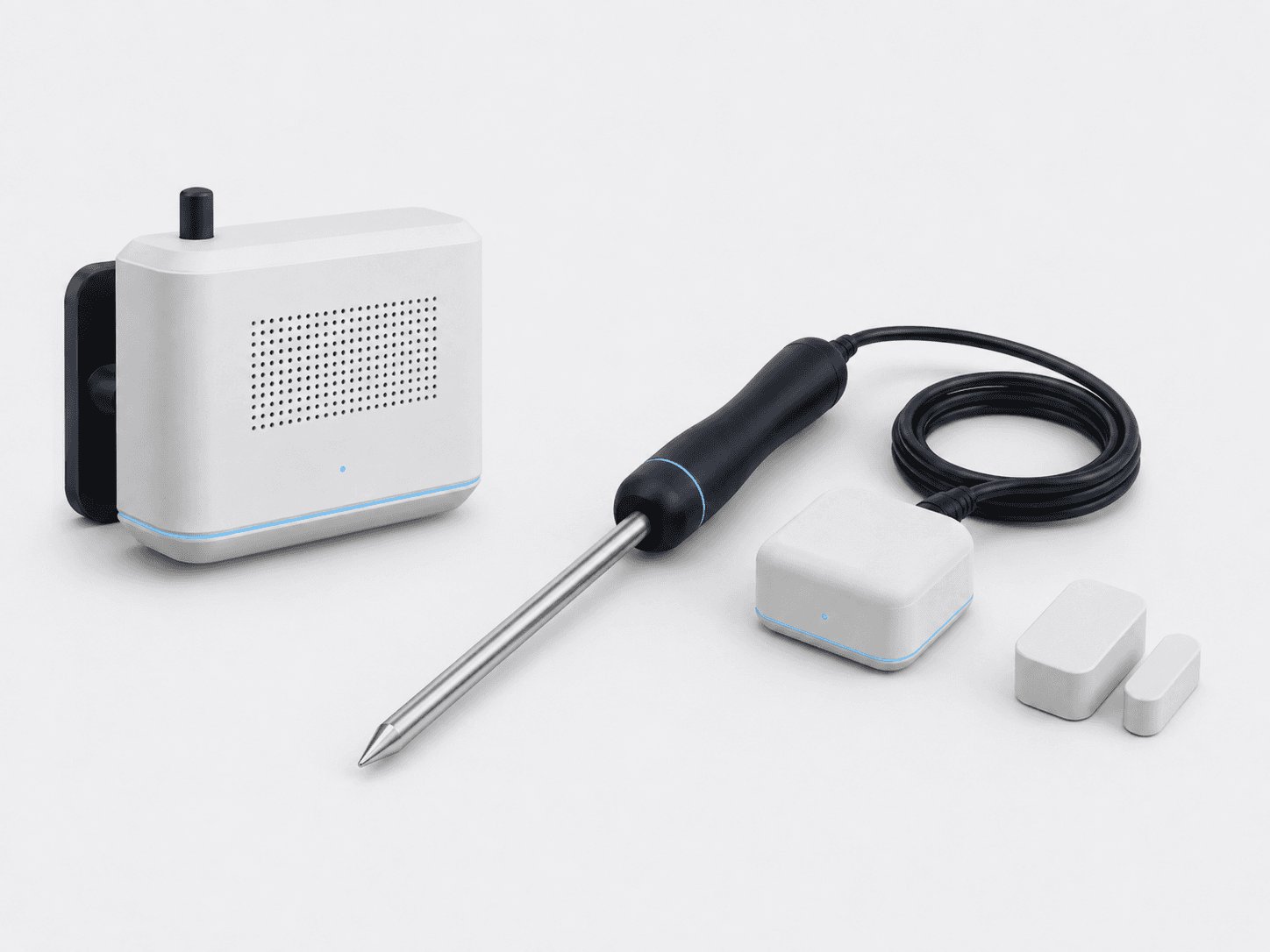 The cold-storage sensing kit: a warm-white chamber air node, a stainless pulp probe with a navy handle, and a magnetic door-state sensor pair.