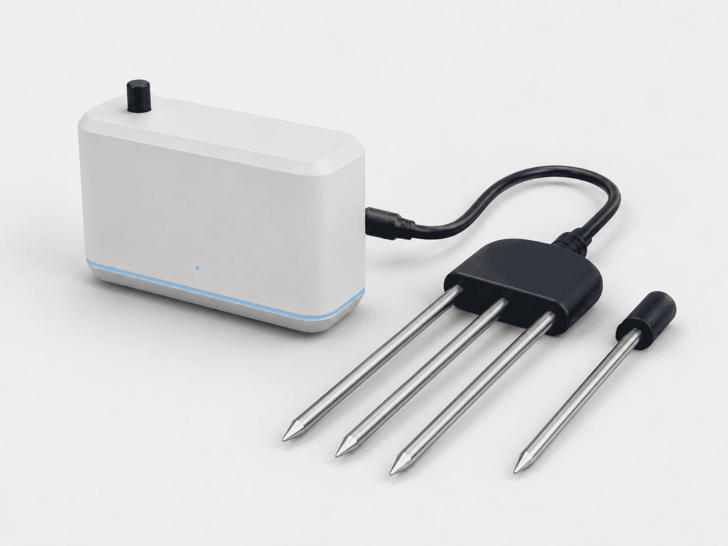 A warm-white root-zone transmitter connected to a stainless three-tine soil probe, with a separate soil-temperature spike.